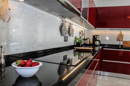 a kitchen with a bowl of strawberries on a counter at The Birds Nest in Alvor