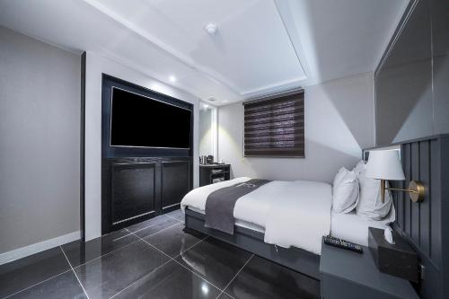 a bedroom with a large bed and a television at Hotel Duruwa Main Building in Incheon