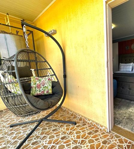 a hanging swing with a pillow on a porch at Exquisite short and long stay in Gaborone