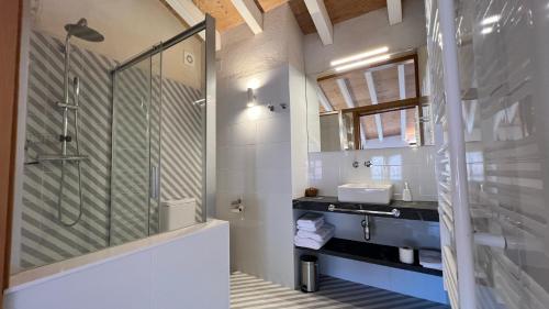 a bathroom with a glass shower and a sink at la Creveta in Tivissa