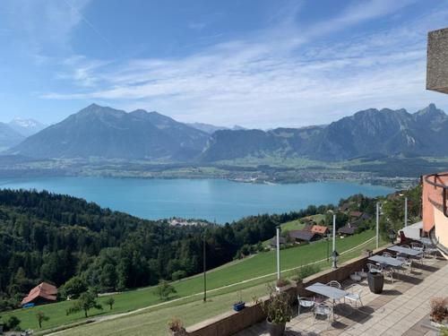 a view of a body of water with mountains at Rooms Haltenegg in Heiligenschwendi