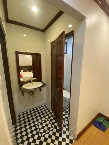 a bathroom with a sink and a mirror at Golden Lotus Boutique Hotel in Luang Prabang