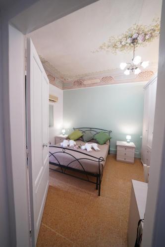 a bedroom with a bed and a ceiling at Regina Stella in Lascari
