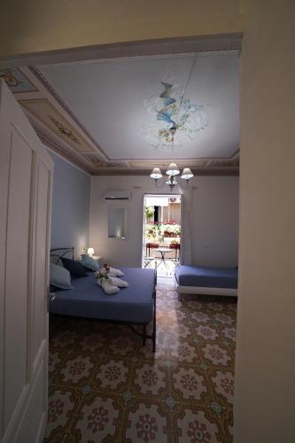 a bedroom with a bed and a ceiling at Regina Stella in Lascari