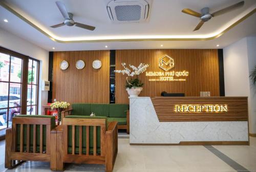 a lobby of a restaurant with a reception desk at Mimosa Hotel Phú Quốc in Phu Quoc