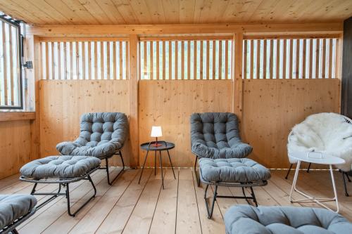 a room with three blue chairs and a table at Ferienwohnung Gertrud in Bezau