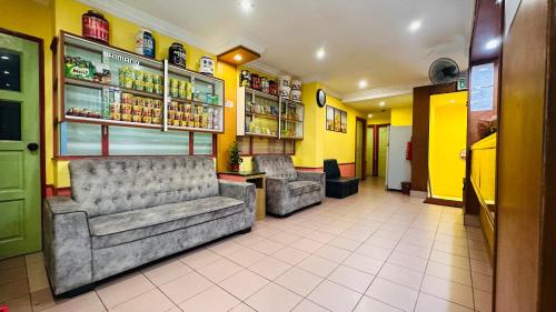 a waiting room with two couches in a restaurant at Mandarin Inn by Glex in Mukah