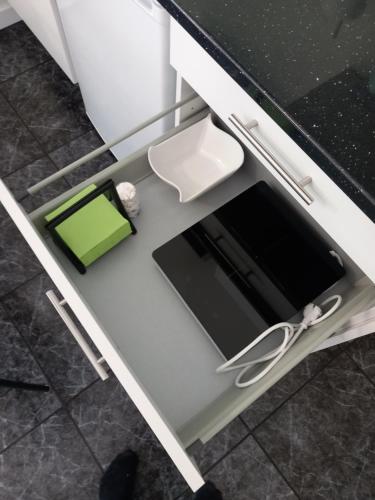 a drawer with a tablet on top of a kitchen counter at Casa Porta do Sol in Estremoz