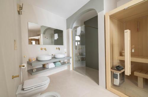 a bathroom with a toilet and a walk in shower at Dimora Antelmi - Tra Cielo & Mare in Ostuni