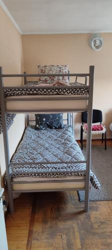 a top bunk of a bunk bed in a room at Genius Hostel Center with Grill zone and yard in Chişinău