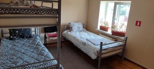 a bedroom with two bunk beds and a window at Genius Hostel Center with Grill zone and yard in Chişinău