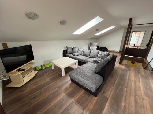 a living room with a couch and a flat screen tv at Soo Rendimaja in Võru