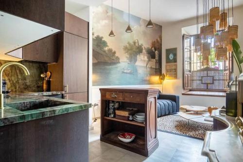 a kitchen with a large painting on the wall at Designer Apartment in Seville