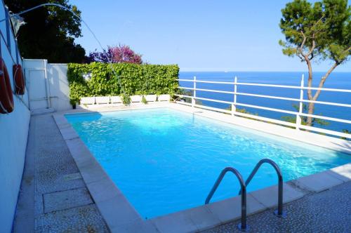 a swimming pool with the ocean in the background at Sea View Sirolo di Amedeo in Sirolo