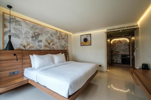 a bedroom with a large white bed in a room at Indie Stays Jaipur in Jaipur