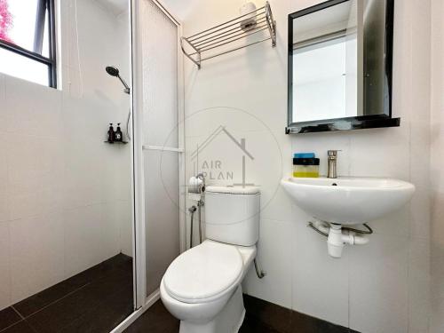 a white bathroom with a toilet and a sink at PD D’Wharf Seaview & Sunset Suite (Up to 3 Pax) in Port Dickson