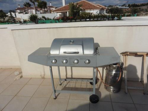 a grill sitting on top of a patio at Lovely 1 bedroom attached apartment with kitchen but private with seasonable pool in Albox