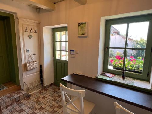a home office with a table and a window at Pannonhalma Várlak Vendégház in Pannonhalma