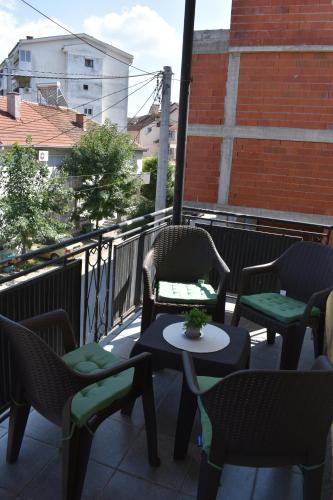 a patio with chairs and tables on a balcony at MANEVI Apartment in Strumica