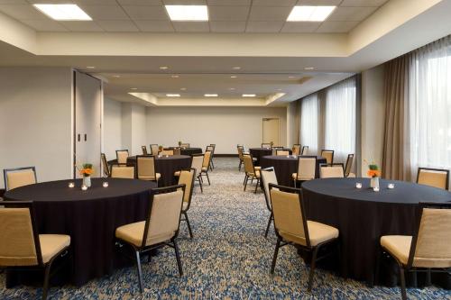 a conference room with tables and chairs in it at Embassy Suites by Hilton Boston Waltham in Waltham
