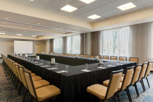 a large conference room with a long table and chairs at Embassy Suites by Hilton Boston Waltham in Waltham