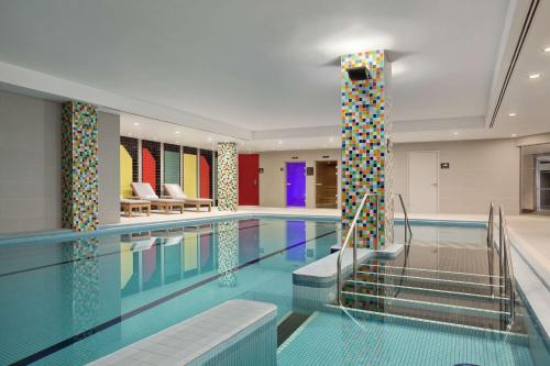 a large swimming pool with a pool at Hilton London Wembley in London