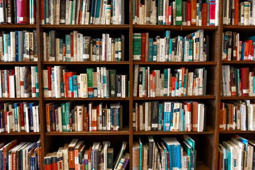 a book shelf filled with lots of books at Holiday Inn Express & Suites Batesville, an IHG Hotel in Batesville