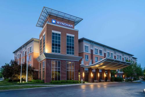 a building with a sign on the side of it at Wyndham Noblesville in Noblesville
