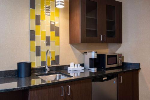 a kitchen with a sink and a microwave at Wyndham Noblesville in Noblesville
