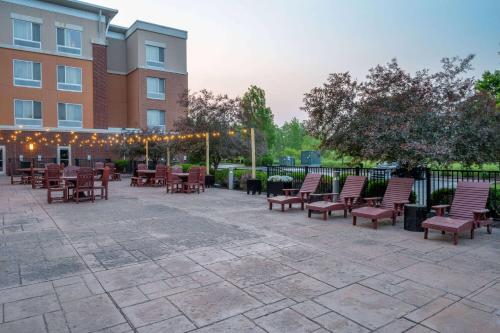 a patio with tables and chairs in front of a building at Wyndham Noblesville in Noblesville