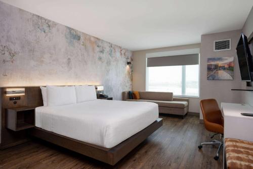 a hotel room with a large bed and a desk at Wyndham Westfield in Westfield