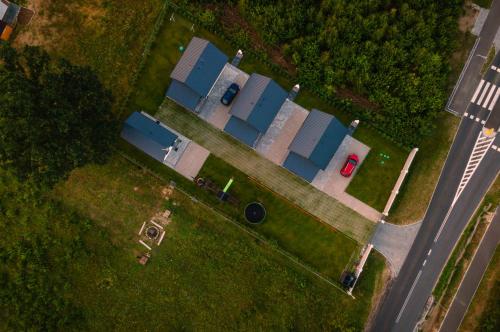an overhead view of a house with blue roofs at Domki Pod Dębem in Sulęczyno