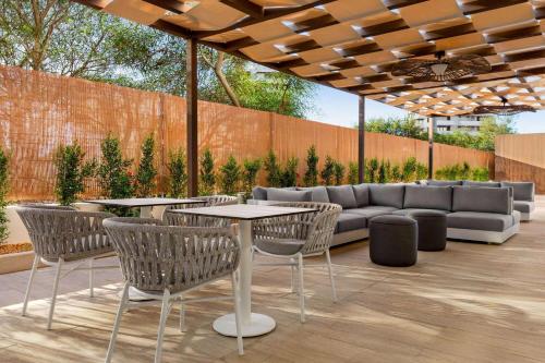 a patio with a couch and tables and chairs at Wyndham Residences Alvor Beach in Alvor