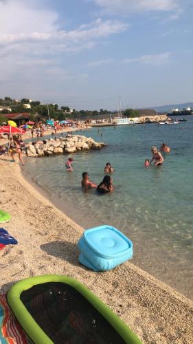 a group of people in the water at a beach at Vanessi in Dugi Rat