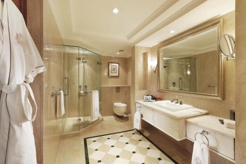 a bathroom with a sink and a shower and a toilet at The Imperial, New Delhi in New Delhi