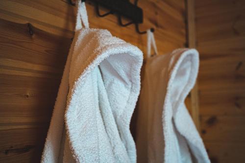 a group of white towels hanging on a wall at Cottage Caucasus in Stepantsminda