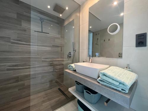 a bathroom with a white sink and a mirror at Casa Punta Prima III in Orihuela Costa