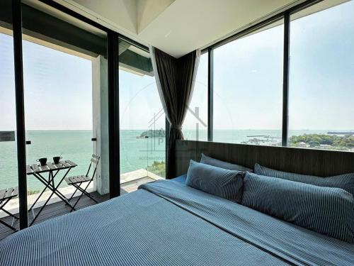 a bedroom with a bed with a view of the ocean at PD D'Wharf Duplex 3BR - Full Seaview (Up To 12 Pax) in Port Dickson