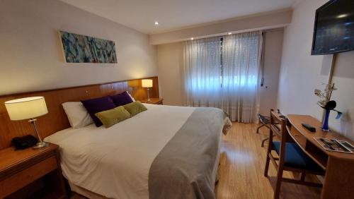 Postel nebo postele na pokoji v ubytování Ñikén Hotel & Spa
