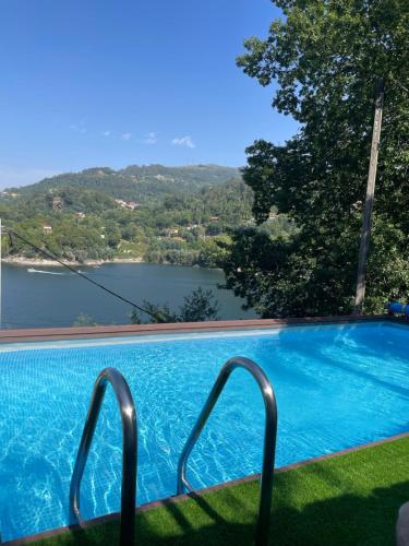 a swimming pool with a view of a lake at Estrela do Geres in Geres