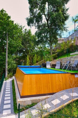 a swimming pool in a yard with two chairs at Estrela do Geres in Geres