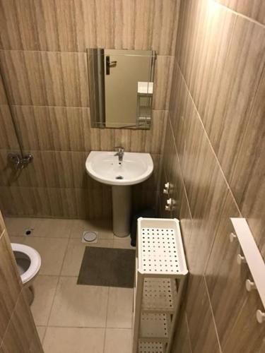 a small bathroom with a sink and a mirror at iReal Rent - Amman/ Jordan in Amman