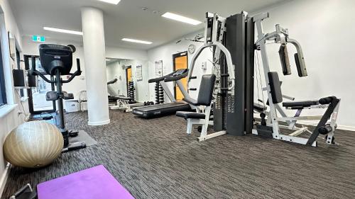 a gym with several treadmills and exercise bikes at Eliza's Lookout in Perth