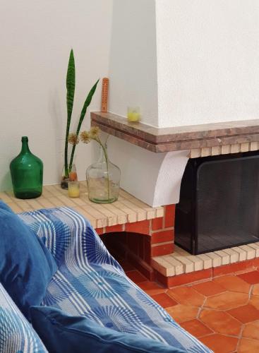 a living room with a couch and a fireplace at Casa Verão Azul - Algarve in Porches