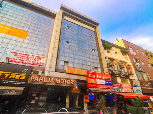 a large building with many signs on it on a street at Hotel Grace, Karol Bagh, New Delhi in New Delhi