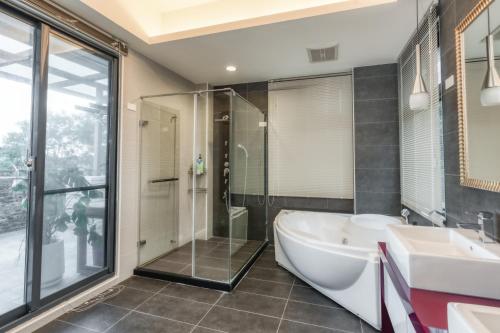 花蓮市的住宿－漫公館-烏曼斯的天空，带浴缸、淋浴和盥洗盆的浴室