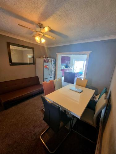 a room with a table and chairs and a couch at Comfortable Single Room in Welling