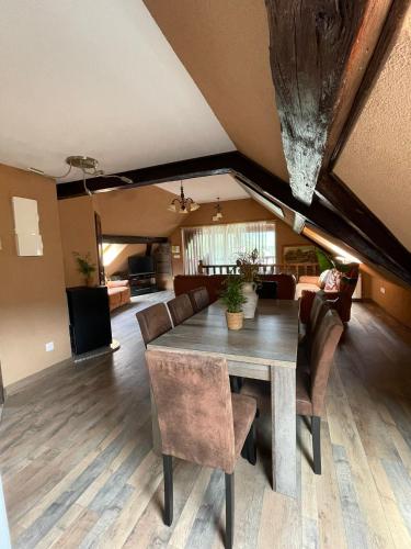 a dining room with a table and chairs at CHEZ ESTER in Plainfaing