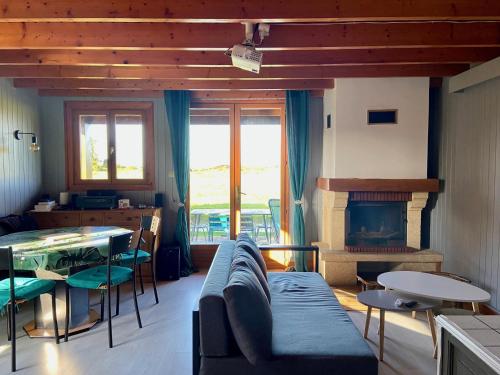 a living room with a couch and a fireplace at Chalet 6 pers avec piscine in Cabourg