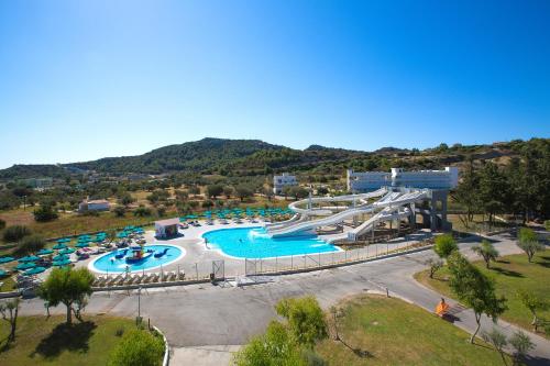 a large swimming pool with a water park at Cyprotel Faliraki in Faliraki